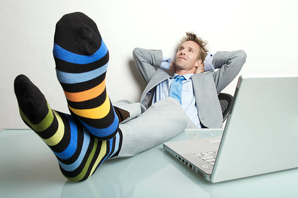 istock Businessman Office Worker Relaxing with Feet Up on Desk 173836311