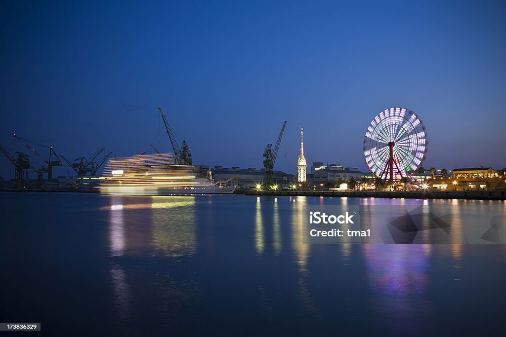Kobe Harbor Nights "Giant Wheel and approaching Cruise Ship at a late Kobe Harbor, Japan." Amusement Park Stock Photo