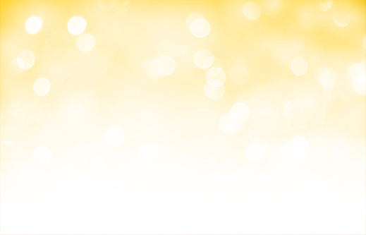 Blank empty horizontal creative glittering shiny yellow gold beige coloured backgrounds with a soft focus. Glamorous and sparkling romantic backdrop suitable to use celebrations wallpaper, backdrops, gift wrapping paper sheets, Xmas greeting cards templates related to parties, birthdays, Christmas, Diwali, New Year Day.