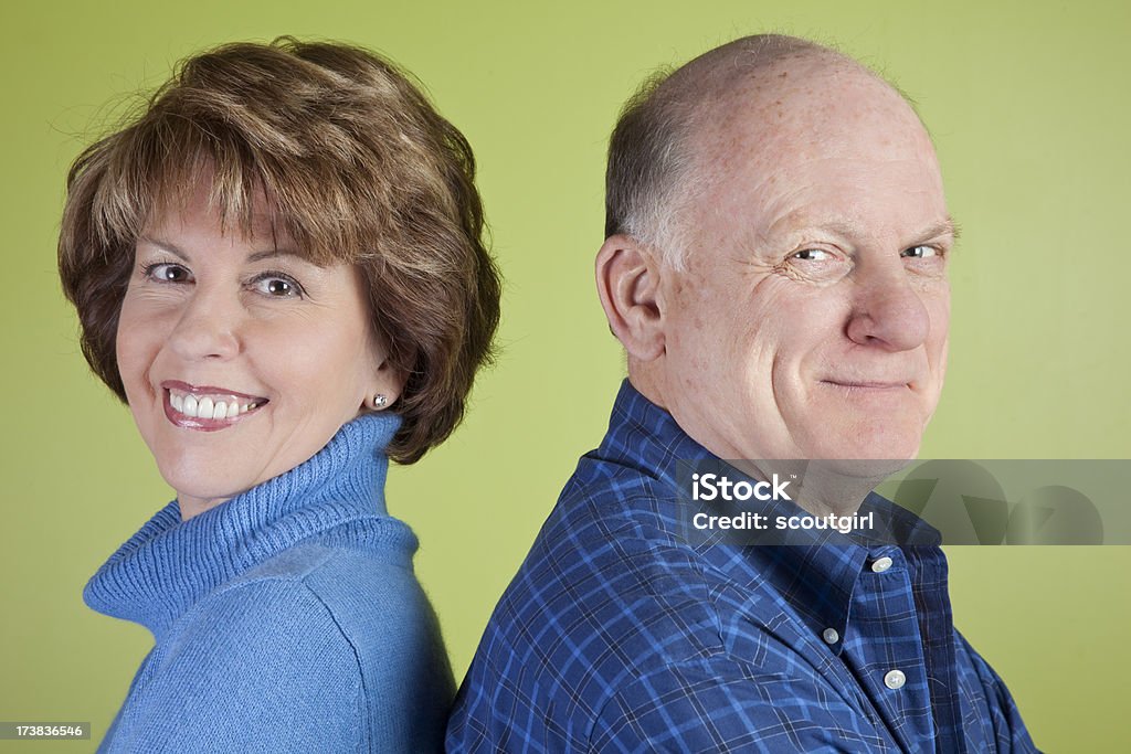 happy couple a male and female back to back smiling at the camera AARP Stock Photo