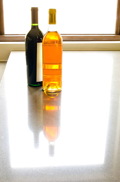 istock Wine Bottles on Granite Counter with Reflection and Window Light 173836956