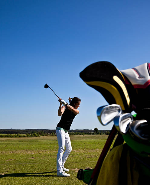 istock young woman on the driving range backswing position 173837408