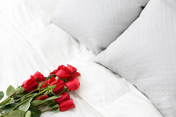 istock Bouquet of Red Roses on White Bed, Copy Space 173837462