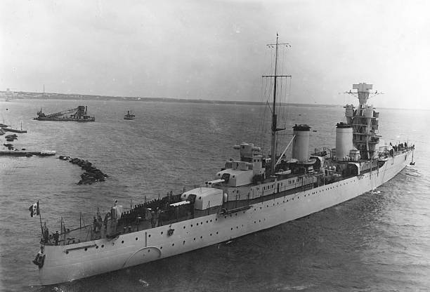 Italian Warship Leaving the Harbor in 1941.Black And White. Some scratchs and grain. Scanned print. battleship photos stock pictures, royalty-free photos & images