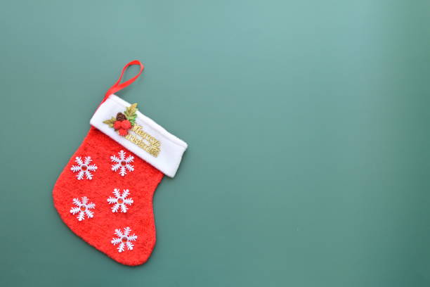 istock red wool winter sock on green background, christmas decoration 1738381182
