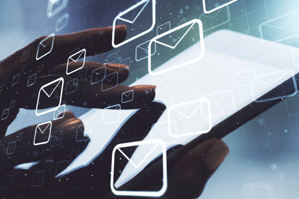 istock Creative abstract postal envelopes hologram with finger presses on a digital tablet on background, email and notification concept. Multiexposure 1738393356