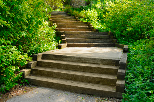 This outdoor staircase is made from oak railroad ties. This is a very sturdy and long lasting outdoor stair building technique. It is also simpler than most other forms of staircase construction. The large wood timbers are very harmonious with the landscaping as well.  More deck and patio images...