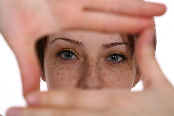 Woman imaging with her hands in the shape of a square Young female looking through a finger frame. determination focus the bigger picture human hand stock pictures, royalty-free photos & images