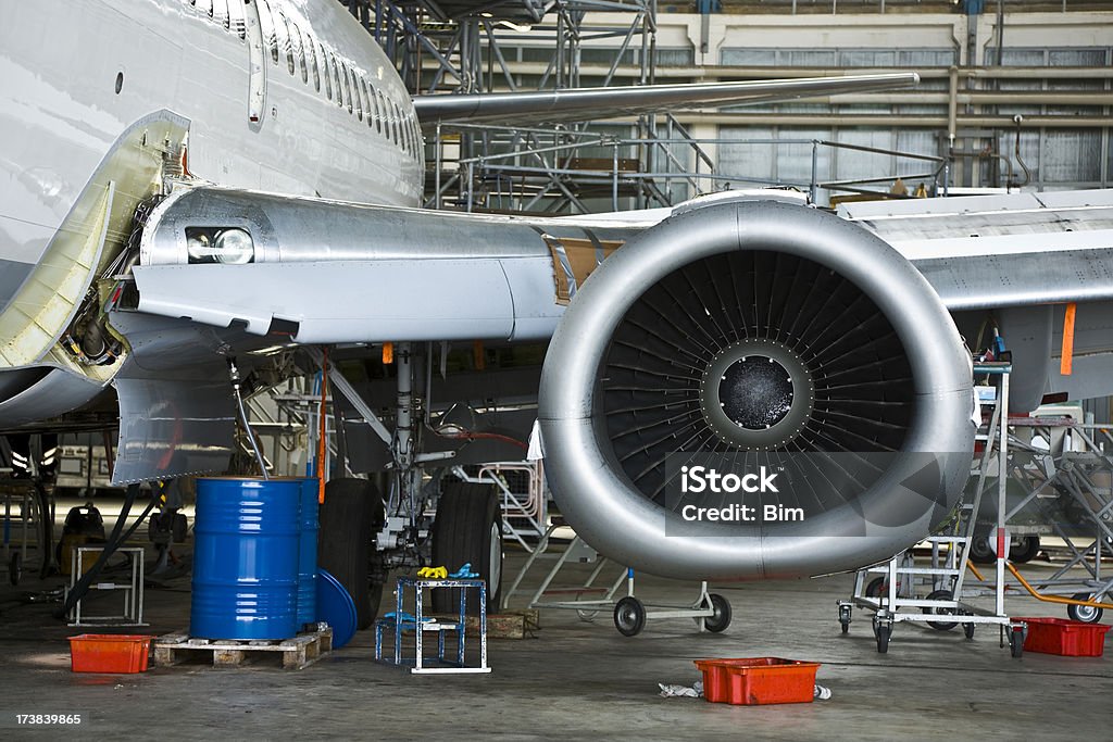Commercial Airplane Maintenance Check in Hangar "passenger jet inspection in hangar, fuselage, left wing and turbine of a Boeing 737-500,click on lightboxes below to view more related images:" Airplane Stock Photo