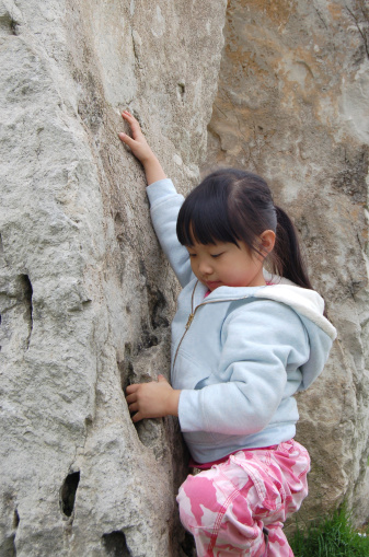 Little girl learning rock climbing
