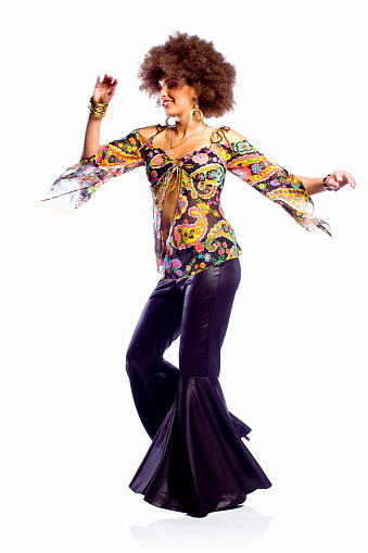 Dancing woman dressed in 70's styled clothing.