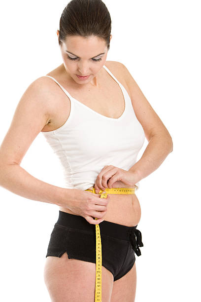 istock Woman measuring her waist 173840776