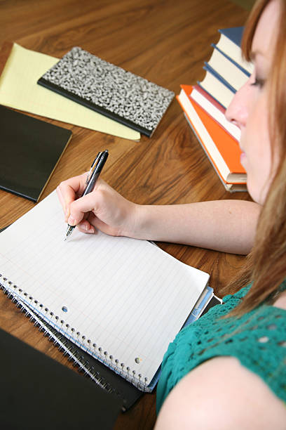 istock Looking Over Shoulder of Female Student Writing 173841683