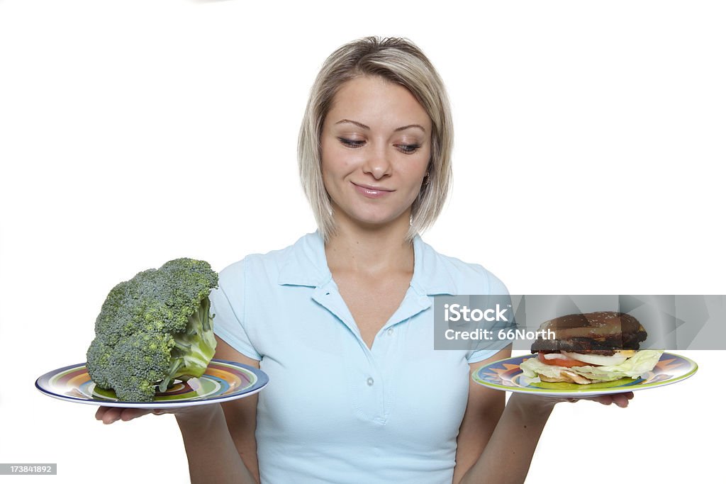 Culpable placer de una hamburguesa o el brócoli sanos - Foto de stock de Adolescente libre de derechos