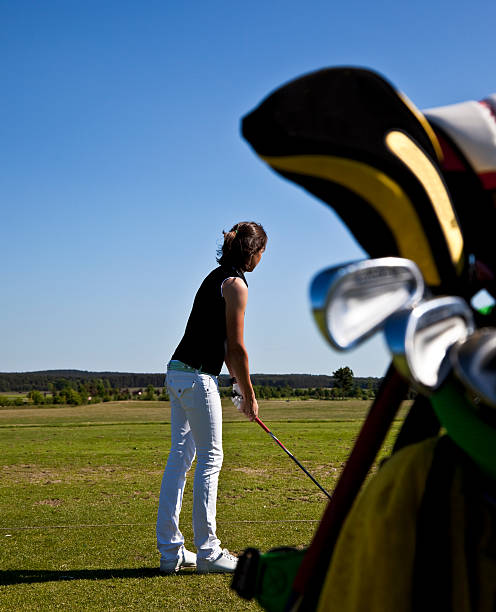 istock woman on the golf course preparing to hit 173842036