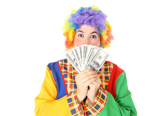 A woman dressed as a clown holding US currency. 