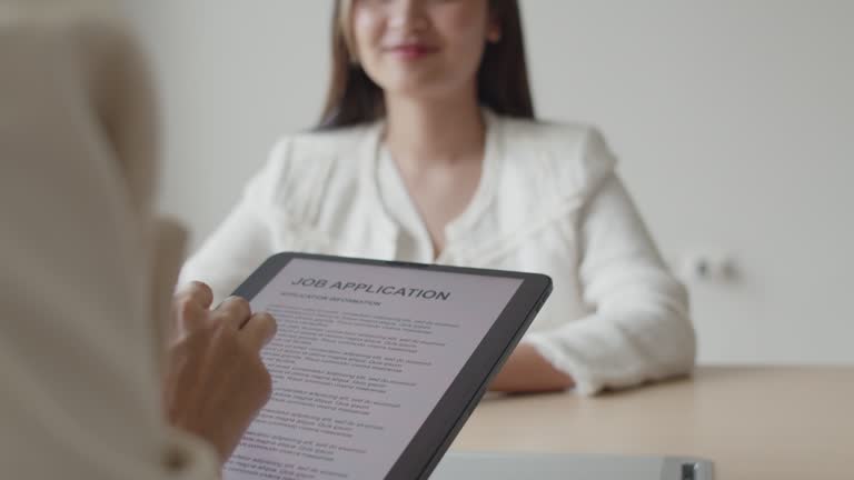 Company owner manager interviewing a new employee in a meeting room in the office.