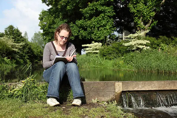 Photo of Woman writing in her Diary