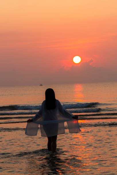 istock Woman pretty with bikini and silhouette on beach 1738437006