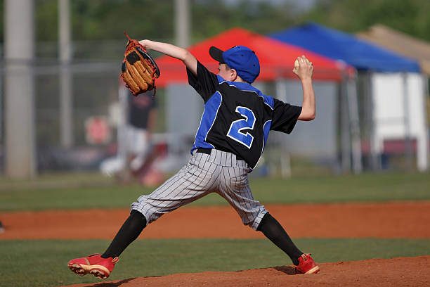 istock Child playing baseball and throwing ball 173843959