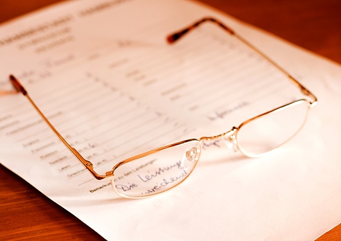 close up of a glasses on a german high school attestation