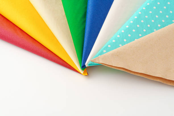 Colorful stack of paper napkins on white background studio shot