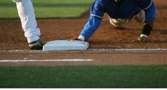 a baseball player sliding back to first