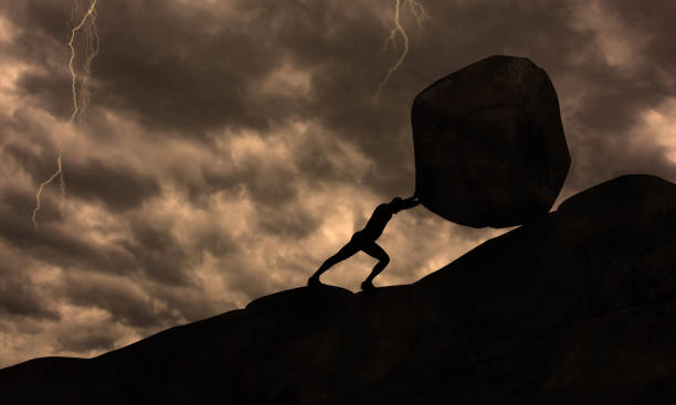 Strong man Pushing uphill Big Concrete Stone At rainy Cloudy Sky Thunder Storm . Businessman Push The Heavy Boulder up To The top of Mountain. Sisyphus , Hard Work and Don't give Up Conceit Strong man Pushing uphill Big Concrete Stone At rainy Cloudy Sky Thunder Storm . Businessman Push The Heavy Boulder up To The top of Mountain. Sisyphus , Hard Work and Don't give Up Conceit sisyphus stock pictures, royalty-free photos & images