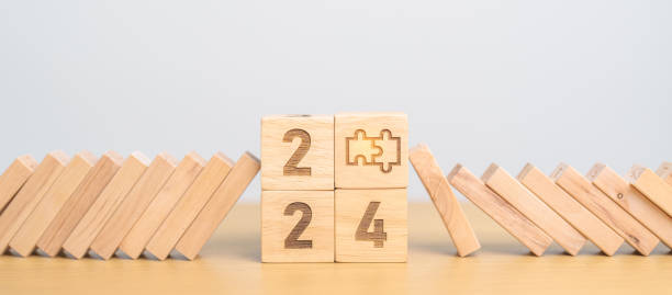 istock 2024 year and falling blocks with jigsaw puzzle icon. Team, teamwork, Goal, mission, strategy, plan, Action, partnership, Risk Management, recession, goal, New Year planning and inflation economy 1738473773
