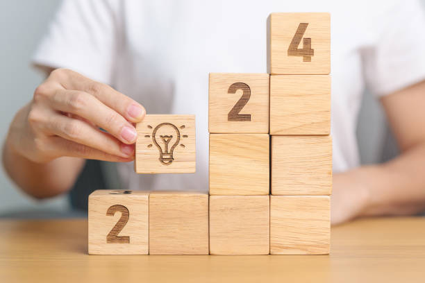 istock 2024 block with lightbulb sign. Idea, Trends, Business Goal, Target, Resolution, strategy, plan, Action motivation, mission, thinking, and New Year start concepts 1738474304