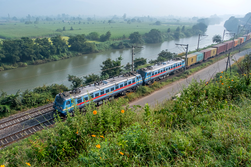 Pune, India - October 15 2023: Container freight train hauled by WAG7 twin electric locomotives near Pune India.