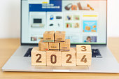 2024 New Year Online Shopping concept. Shipping Boxes on laptop computer. Sale and discount during Christmas and New Year holiday, ecommerce, shipping delivery, logistics and Cyber Monday