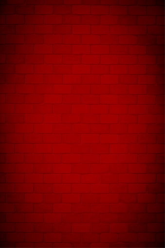 A bright vibrant red maroon colored brick wall with rectangular blocks, textured grungy vertical vector backgrounds. There is no people and copy space. It is a rustic modern backdrop template.