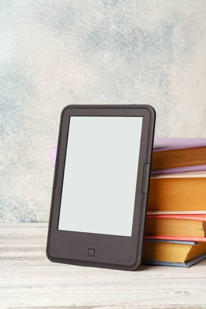 istock Digital tablet with a stack of books on gray background 1738481802