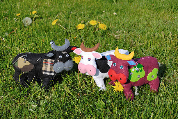 Tree homemade felt cows in the grass