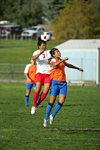 istock Two Female Soccer Players Compete in Header Battle with copyspace 173848780