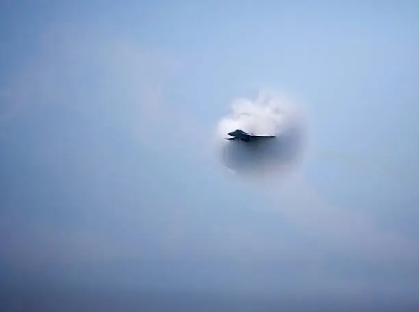 US Air Force F/A 18 Super Hornet Plane approaching the speed of sound, Vapor cloud of Sonic Boom Visible.