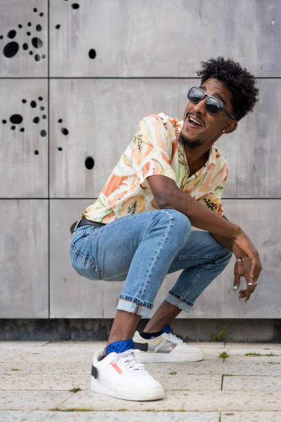 istock Urban afro man crouching while posing outdoors 1738493534