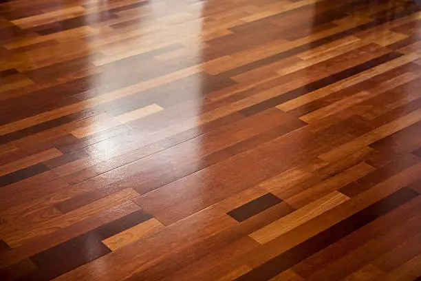 Polished wooden floor texture with diffuse reflections.