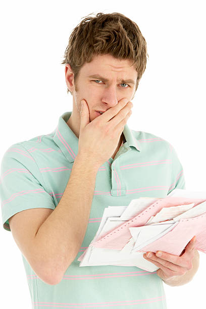 Young Man Holding Stack Of Bills stock photo