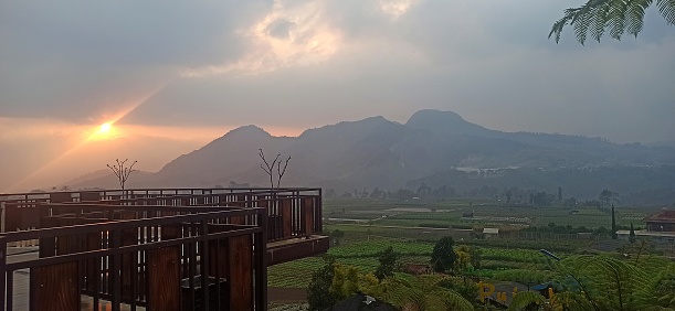 Tables, chairs, sofas at cafes or restaurants in hilly areas. Sun set mountains nature view