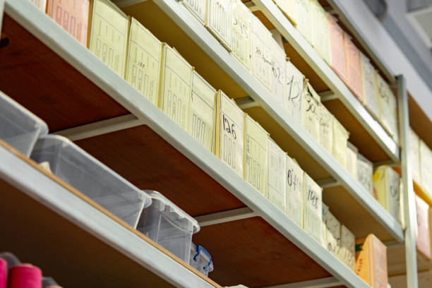 istock Shelving with sewing accessories in boxes in textile factory 1738500662