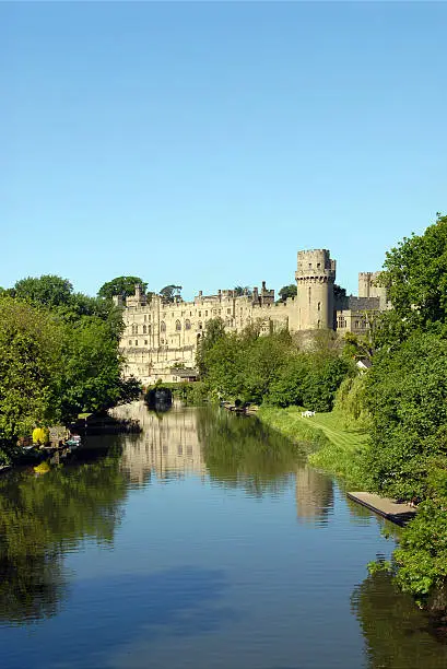 Warwick Castle reflected in the river avon with lots of copy space.