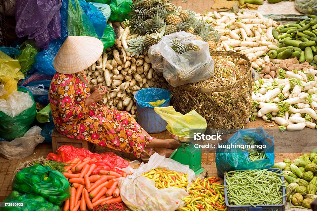 A lady selling various vegetables in Ho Chi Minh, Vietnam vietnamese woman market vendor Market Vendor Stock Photo