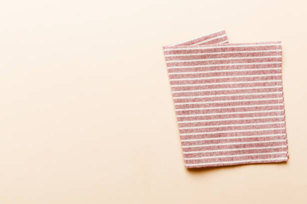 istock top view with red empty kitchen napkin isolated on table background. Folded cloth for mockup with copy space, Flat lay. Minimal style 1738513835