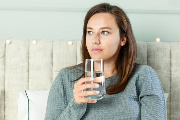 istock Woman drinking water at home 1738518890