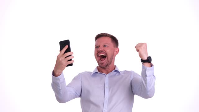 Happy man shouts and waves fists receiving win notification