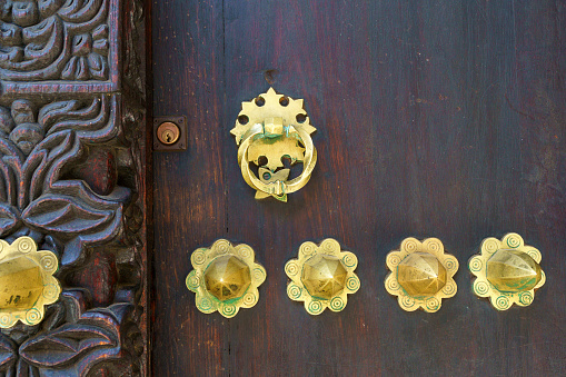 traditional wooden swahili doors in zanzibar made from ebony wood showing classical decoration carving and detail