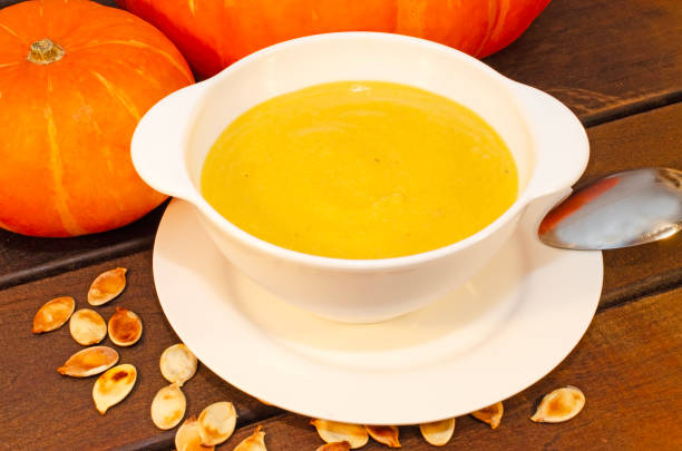 istock Pumpkin hot puree soup on a wooden table. 1738522113