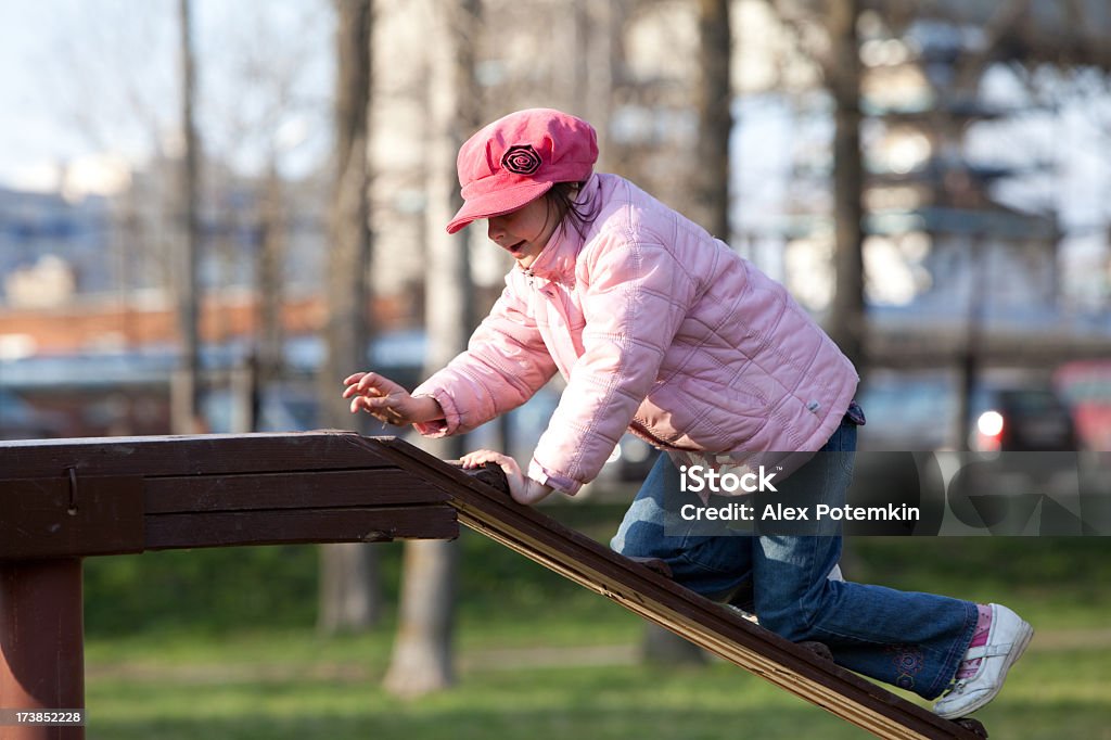 Girl climbing on the play park Little girl on the boom Activity Stock Photo